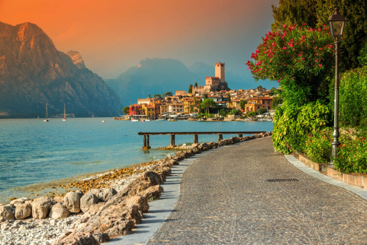 Fantastic Malcesine tourist resort and colorful sunset, Garda lake, Italy